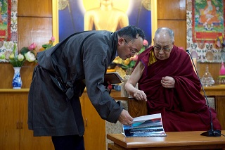 The interpreter was showing the information book to H.H. The Dalai Lama